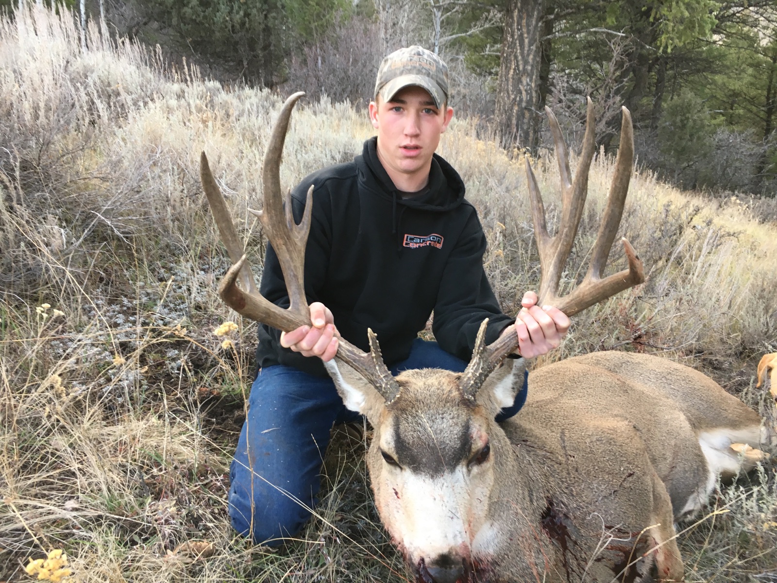 Man with mule deer kill